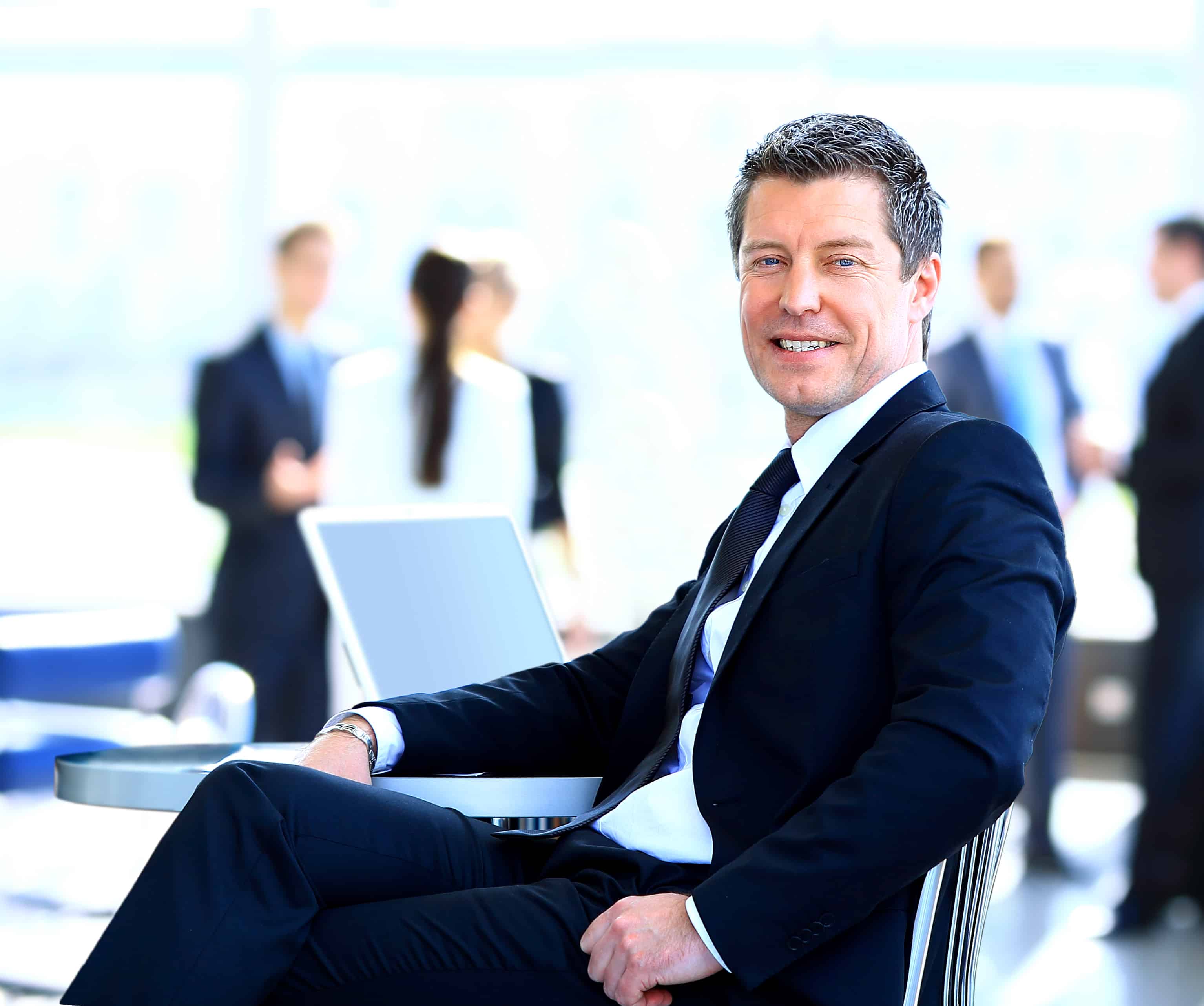 Casual businessman working in office, sitting at desk.
